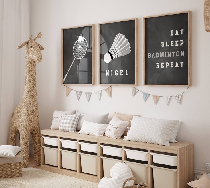 a room with two pictures on the wall and some stuffed giraffes in the corner