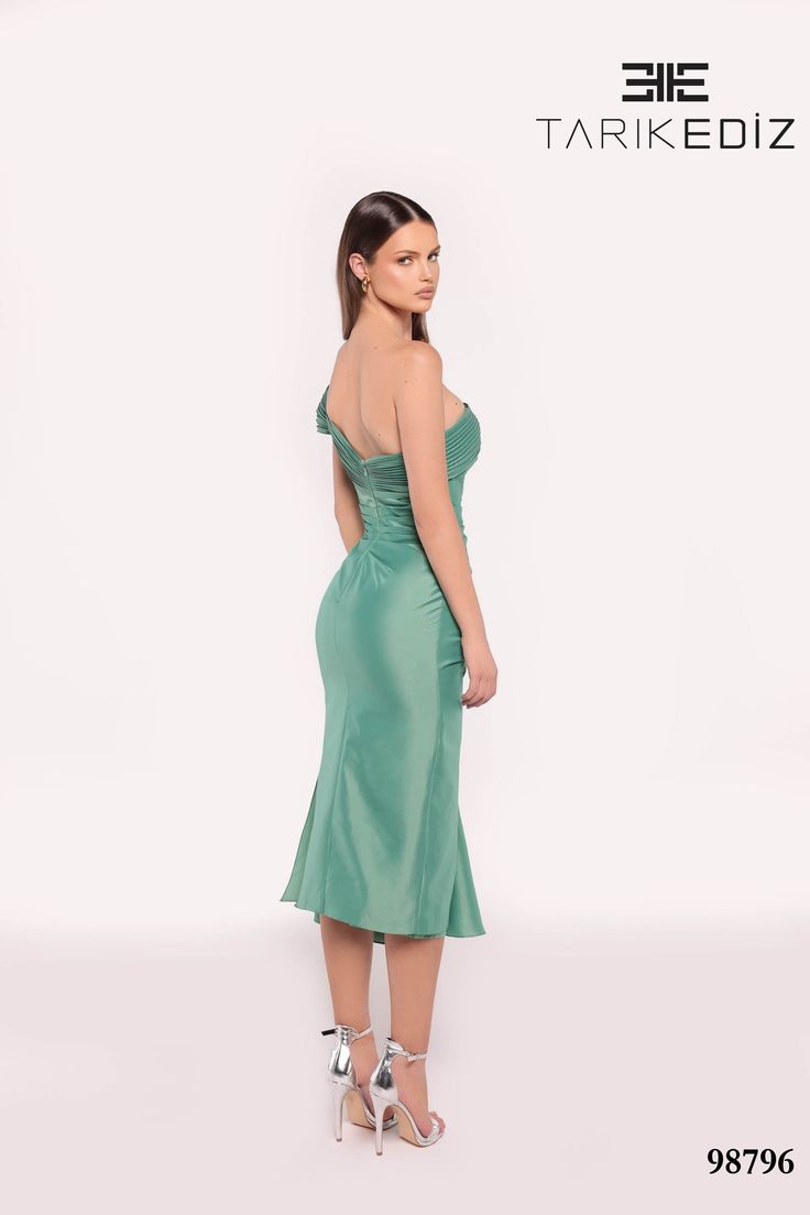 Tarik Ediz 98796 Fall 2024 evening collection dress. Made with Tafetta fabric. Chic Evening Dress With Fitted Bodice For Gala, Sleeveless Satin Evening Dress For Gala, Green Ruched Evening Gown, Strapless Evening Dress With Ruched Asymmetrical Neckline, Evening Strapless Dress With Ruched Asymmetrical Neckline, Evening Dress With Ruched Detail And Asymmetrical Neckline, Green Evening Dress With Sweetheart Neckline, Ruched Evening Dress With Asymmetrical Neckline, Formal Midi Dress With Fitted Bodice For Gala