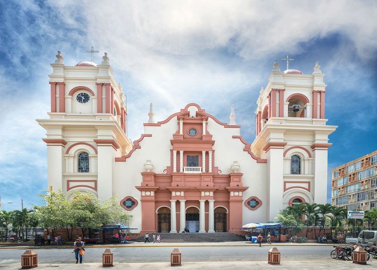 a large white and red building with two towers