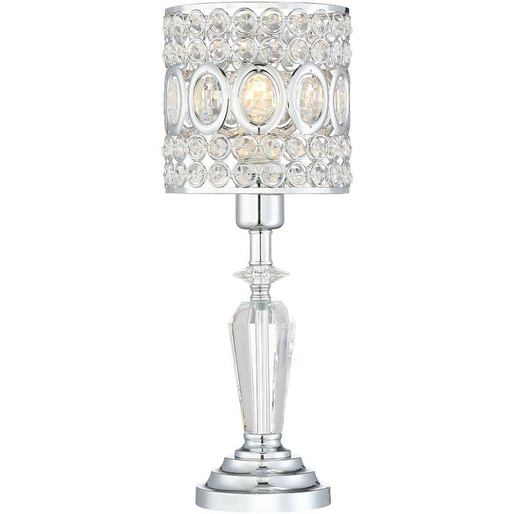 a crystal table lamp with a white shade