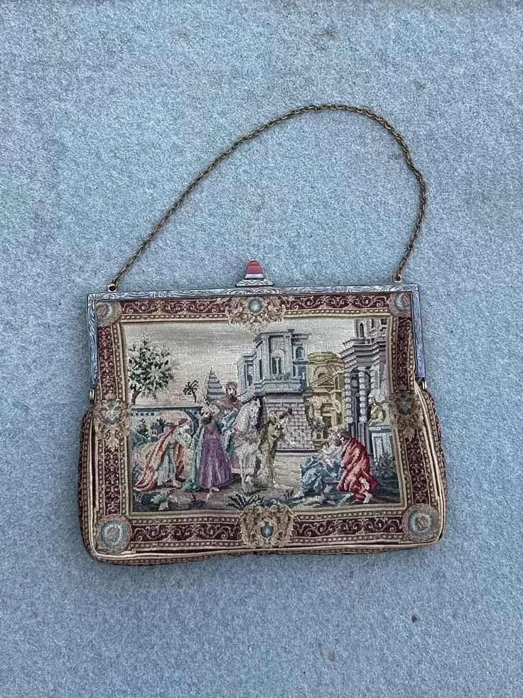 Antique Petit Point Tapestry Scenic Evening Handbag with Polished Carnelian Stone Lock  A lovely antique evening purse or bag with very fine hand embroidered petit point scenes on the front and back.  Each side is similar but depicts a different scene. The frame is engraved metal, and it fastens with a clever closure which is topped with a beautifully polished and shaped carnelian stone.  The inside is lined in silk and it has a small internal foldable wallet.  Purse measures approximately 7.25 inches long by 5.5 inches wide (not including height of stone lock).  Chain measures approximately 5.25 inches long (from top of extended chain to the top of the purse). In great condition for its age with no noticeable flaws. Please see all photos. Antique Embroidered Evening Bags, Vintage Embroidered Rectangular Evening Bag, Victorian Style Embroidered Rectangular Bag, Vintage Tapestry Handmade Bags, Vintage Handmade Tapestry Bag, Victorian Embroidered Evening Bags, Antique Tapestry Evening Bag, Vintage Tapestry Bags For Gifts, Vintage Embroidered Tapestry Shoulder Bag