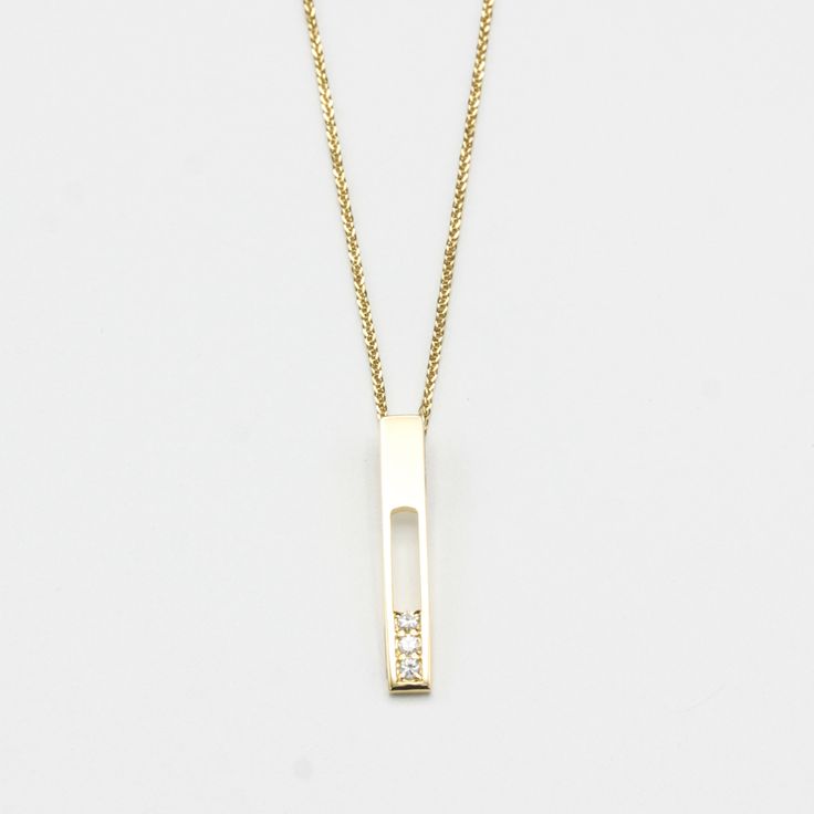 18k gold necklace with vertical gold bar and decorated with 3 diamonds in an elegant line prong setting. Handcraft spring ring clasp closer Necklace measure: 16 inches Pendant measure: 2.5 mm W x 30 mm H Minimalist Diamond Accents Bar Necklace As Gift, Minimalist Diamond Accents Bar Necklace Gift, Minimalist Bar Necklace With Diamond Accents For Gift, Minimalist Bar Necklace With Diamond Accents As Gift, Minimalist Bar Necklace With Diamond Accents, Modern 14k Yellow Gold Bar Necklace, Elegant Silver Rectangular Bar Necklace, Gold Minimalist Diamond Bar Necklace, Minimalist Gold Diamond Bar Necklace