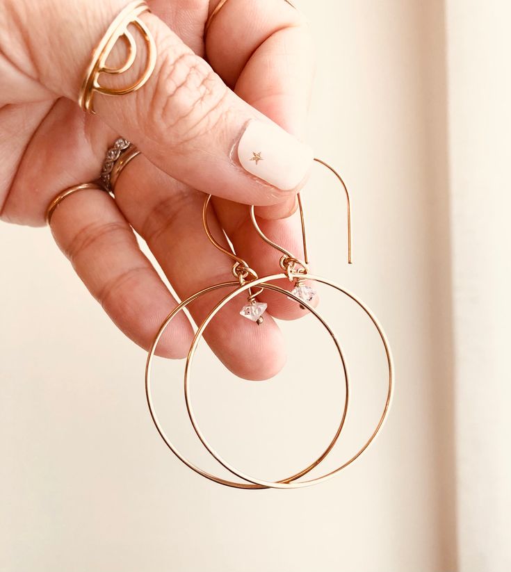 Just as effortless as they are simple, these hoop earrings are an essential everyday piece. Item Details: • This listing is for A PAIR ( 2 pieces ) earrings.• All metal is components are sterling silver and 14k gold-fill• Hoops measure 40mm in diameter.• Herkimer quartz crystals prized, each Herkimer diamond is a natural entity and no stone is identical.• The order will arrive in a gift-wrapped box and free polishing cloth. It will be ready for gift giving. All our work is custom-made by hand in Simple Design 14k Gold Earrings, Hypoallergenic Small Hoop Earrings In 14k Gold Filled, Nickel-free 14k Gold Hoop Jewelry, Everyday Hoop Jewelry In Recycled Gold, Everyday Recycled Gold Hoop Jewelry, Delicate Yellow Gold Hoop Jewelry, Minimalist Everyday Hoop Jewelry, Everyday 14k Gold Small Hoop Jewelry, Everyday Round Huggie Earrings In Recycled Gold