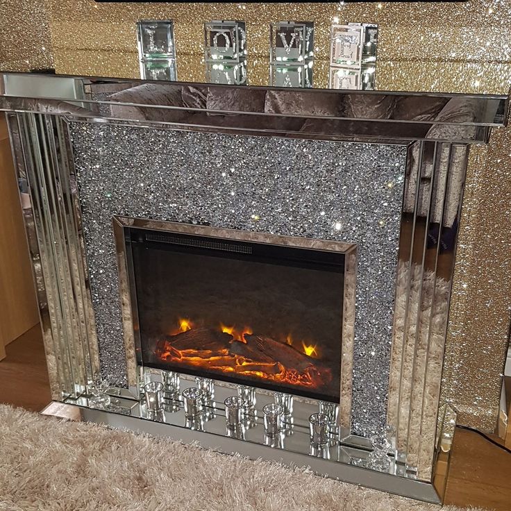 a fireplace that is sitting in the middle of a room with carpet on the floor