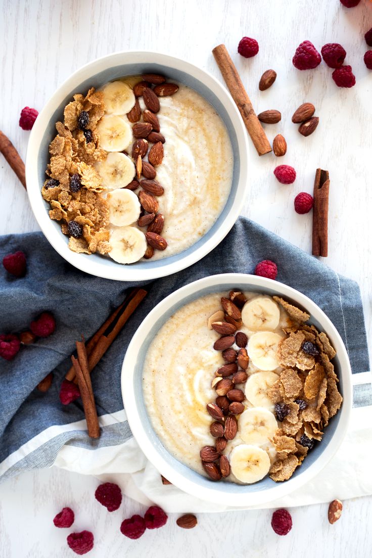 two bowls filled with oatmeal and fruit