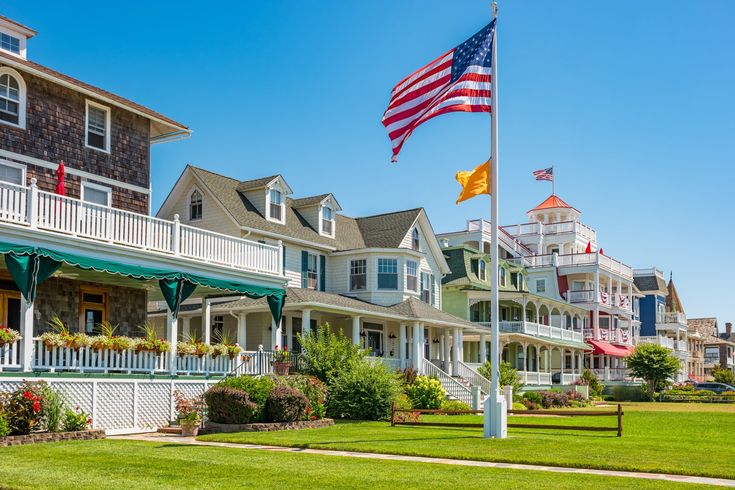 the american flag is flying in front of many houses with balconies on them