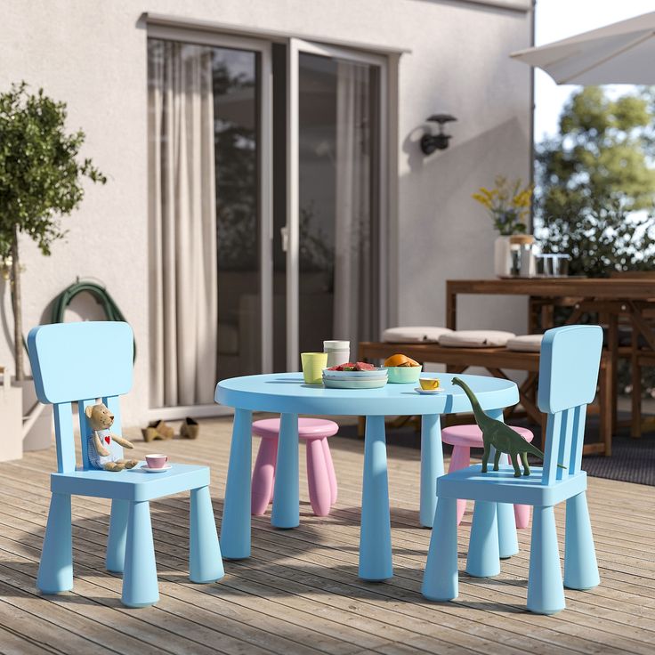 two children's chairs and table on a deck