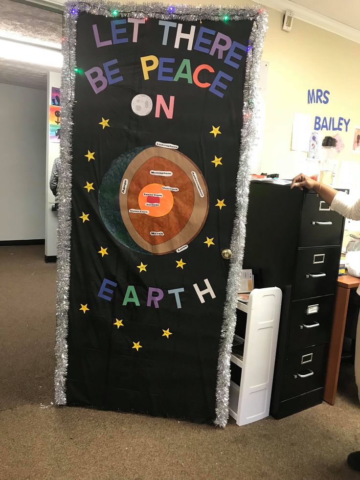 a bulletin board with the words let there be peace on earth in front of it