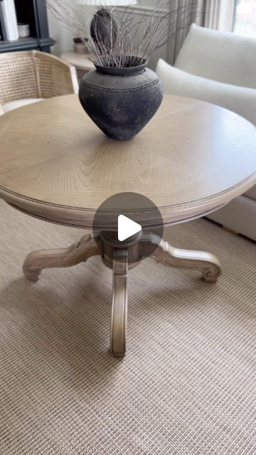 a table with a vase sitting on top of it