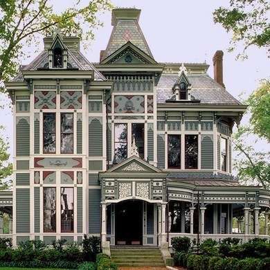 an old victorian style house with many windows