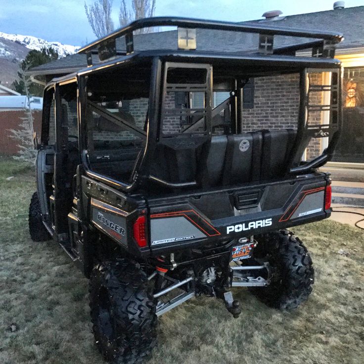 a black polaris vehicle parked in front of a house