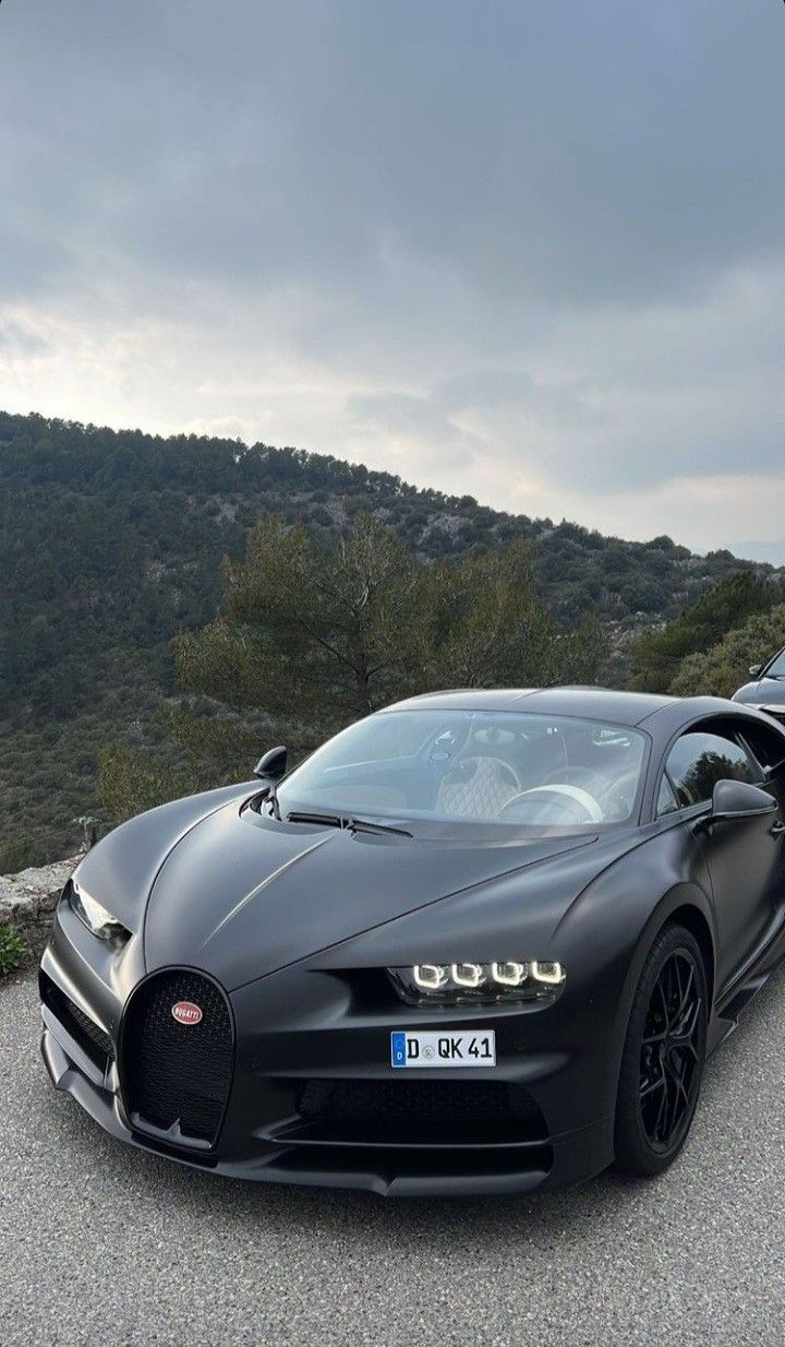 a black bugatti is parked on the road