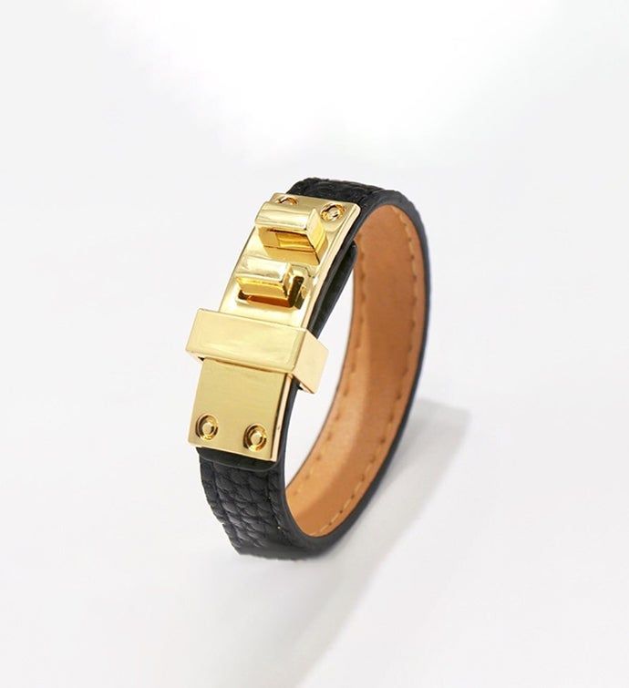 Faux Black Leather Cuff with gold clasp | Faux Black Leather Cuff with gold clasp | 1-800-Flowers Gifts Delivery Faux Black Leather Cuff Adjustable Gold Bracelets With Gold-tone Hardware, Formal Gold Leather Bracelet With Gold-tone Hardware, Formal Gold Leather Cuff Bracelet, Gold Leather Cuff Bracelet For Formal Occasions, Modern Gold Leather Bracelet With Gold-tone Hardware, Adjustable Gold Leather Bracelet Chic Style, Adjustable Gold Leather Bracelet With Gold-tone Hardware, Adjustable Gold Leather Chic Bracelet, Trendy Gold Bracelets With Leather Strap