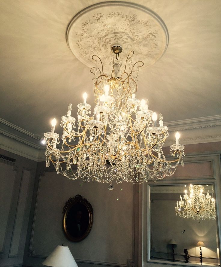 a chandelier hanging from the ceiling in a room