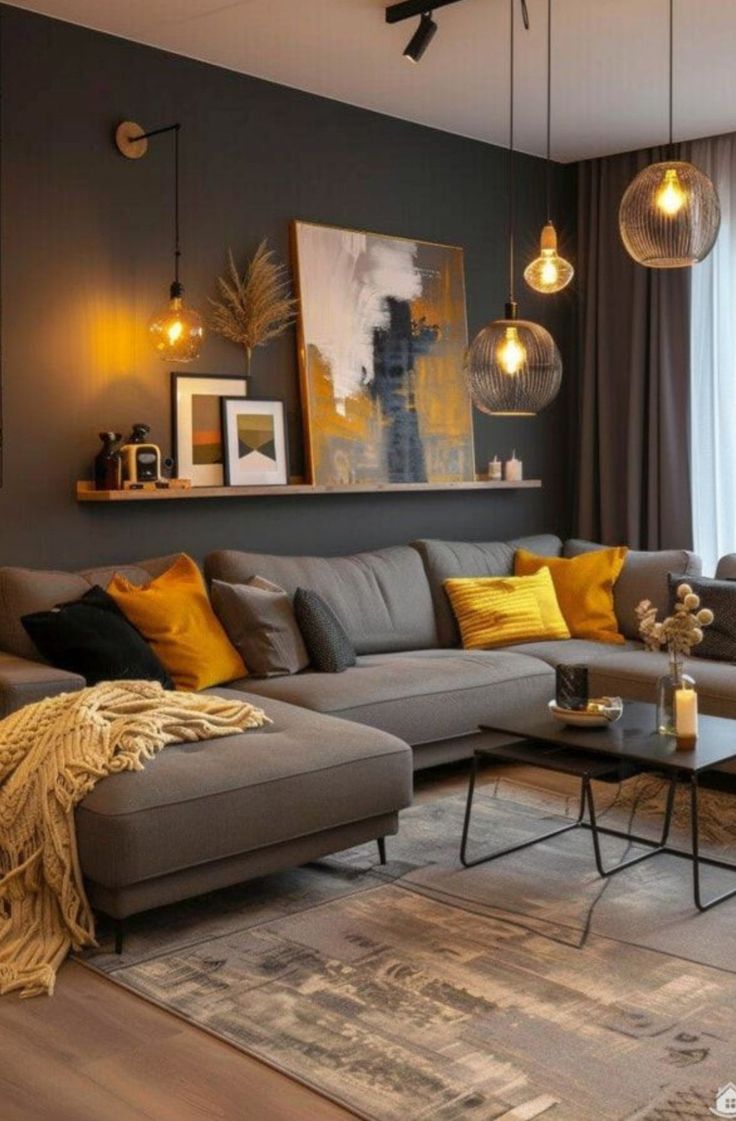 a living room with grey couches and yellow pillows