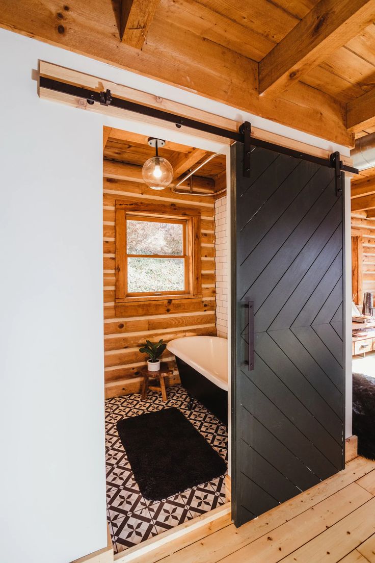 an open door leading to a bathroom in a log cabin