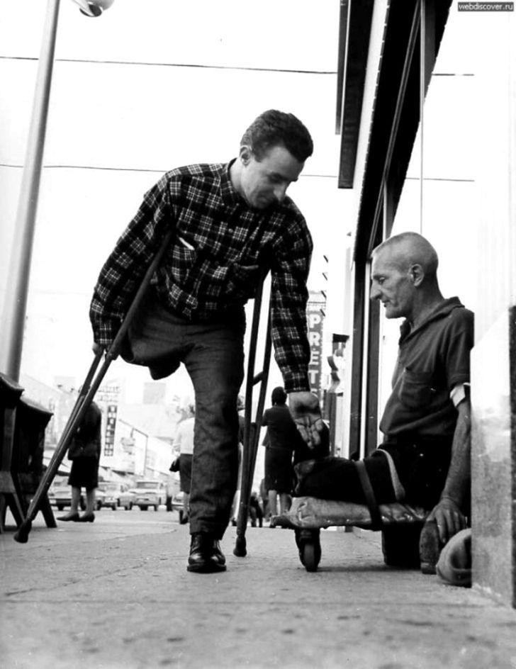 an old photo of two men with crutches