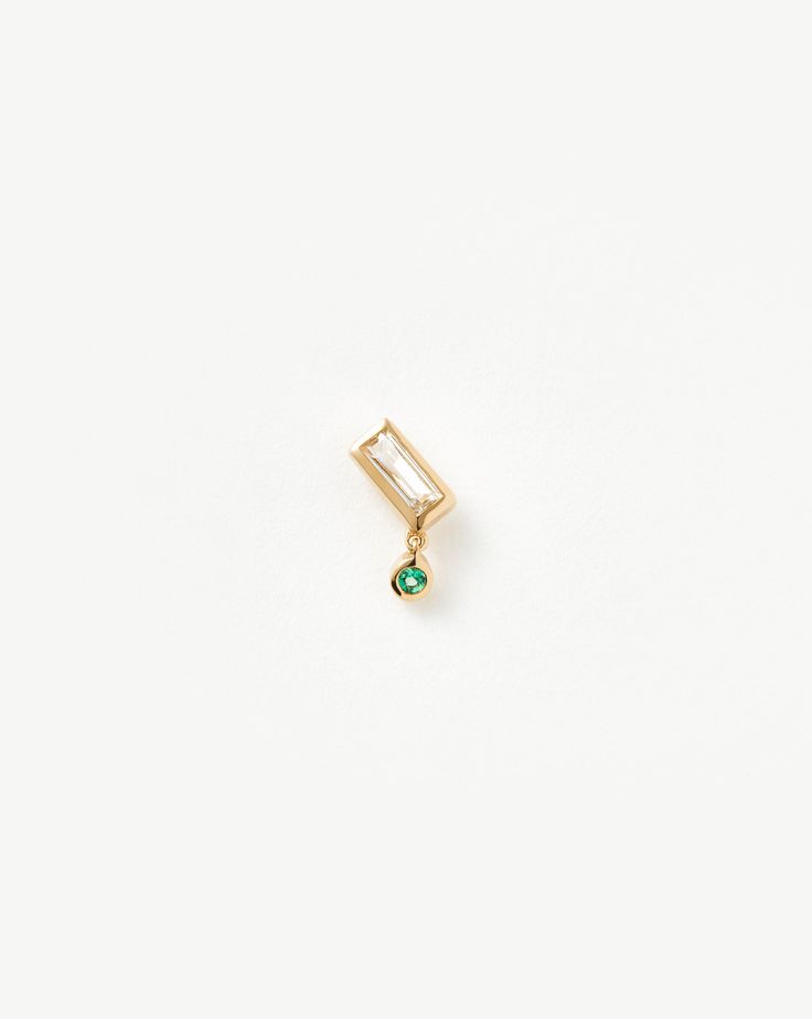 Fine Emerald Single Drop Stud Earring 14ct Solid Gold/Emerald. This Single Drop Earring is an Elevated Take on Our Signature Studs, Featuring a Baguette-Shaped White Topaz Stone with a Drop Round Emerald Charm. Mix and Match with Other Refined Designs. Handcrafted from 100% Certified Recycled Solid Gold, and Hallmarked for Authenticity. Metal: 14Ct Recycled Yellow Gold Dimensions: 4mm X 7. 6mm Gemstone: Emerald Weight: 0. 5g Product Code: Fj-G-E31-Wt-Em-Hf Emerald Style, Demi Fine Jewelry, Topaz Stone, Drop Earring, Recycled Sterling Silver, Conflict Free Diamonds, White Topaz, Stud Earring, Jewelry Care