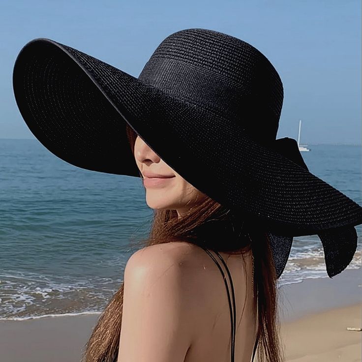 This Wide-Brim Floppy Black Straw Hat Is Perfect For Summer. It's Meticulously Crafted To Provide Shade And Style During Sunny Days, Making It A Popular Choice For Beach Outings And Other Outdoor Activities. The Wide Brim Helps Protect Your Face And Neck From The Sun, While The Floppy Design Gives It A Relaxed And Casual Look. The Black Color Is Versatile And Can Easily Match With Various Outfits, Making It A Practical Choice For Summer Accessorizing. The Bow Trim Band Adds A Touch Of Femininity Floppy Hat Outfit, Black Straw Hat, Floppy Beach Hat, Sun Beach, Outfits With Hats, Beach Hat, Summer Hats, Summer Sun, Wide Brimmed