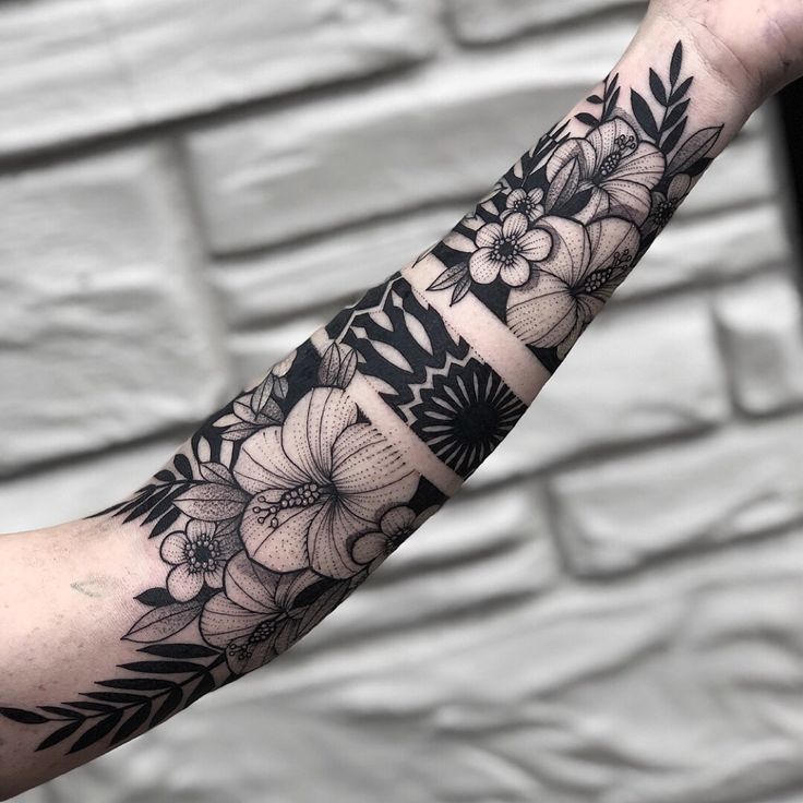 black and white flower tattoo on the arm