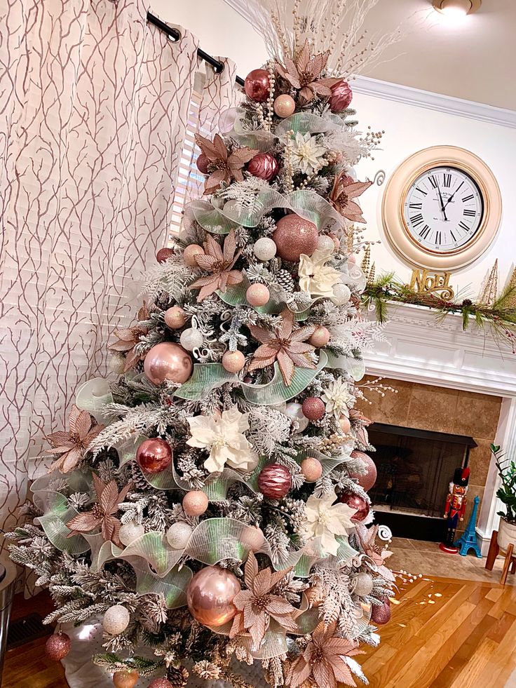 a decorated christmas tree in a living room next to a fireplace with a clock on the wall