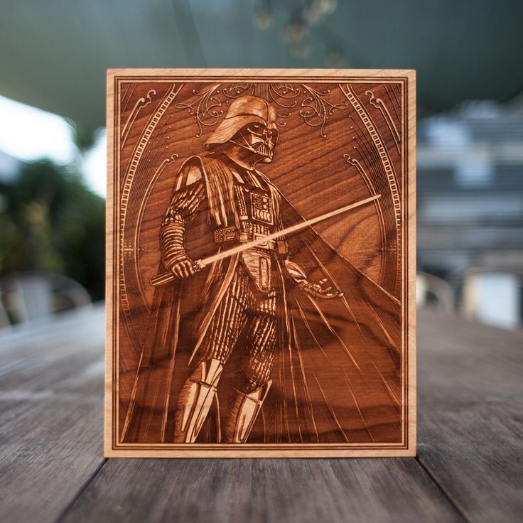 a wooden plaque with a star wars character engraved on it