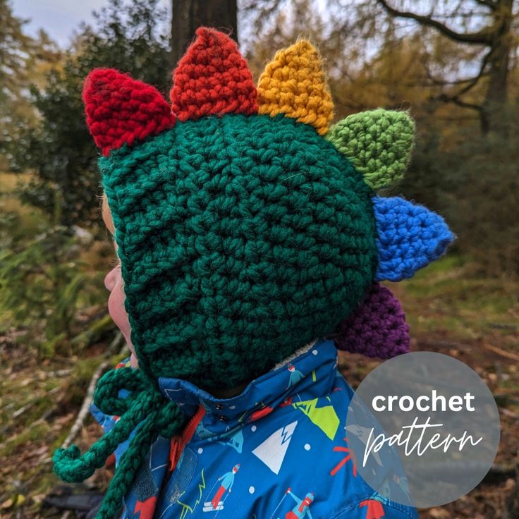 a child wearing a crochet hat with multicolored ears