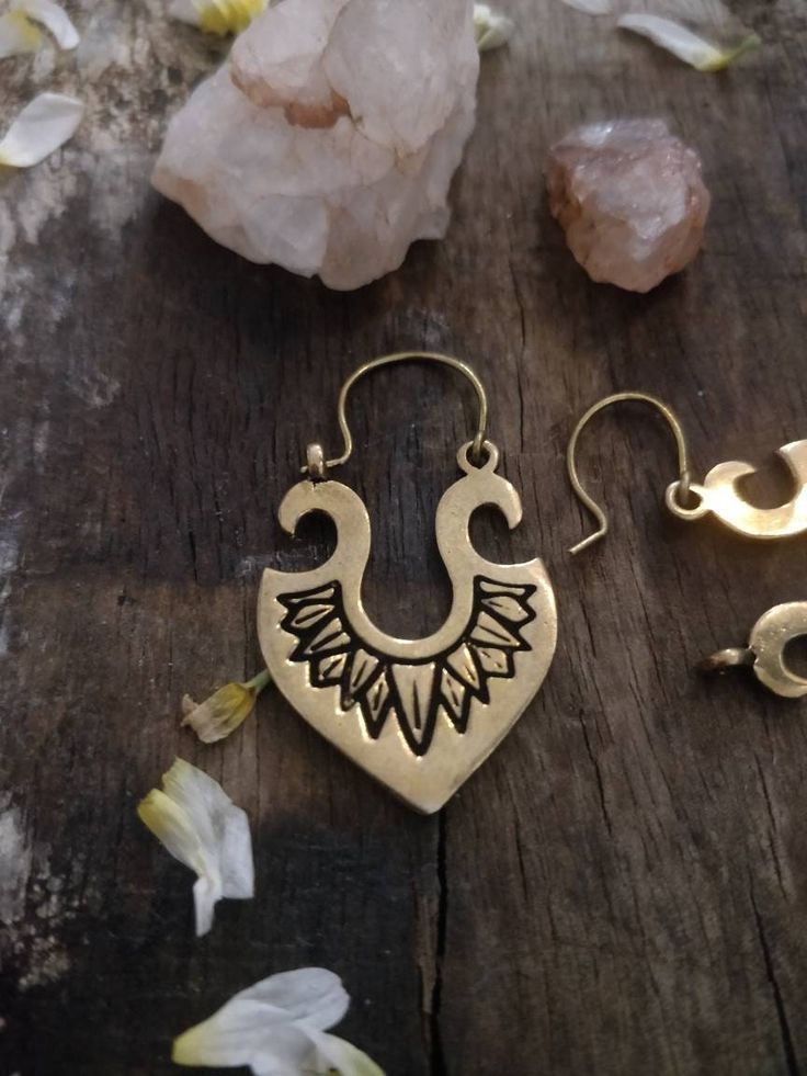 Elevate your boho style game with these stunning Tribal Danglers. Handmade with love and attention to detail, these earrings feature a gorgeous vintage boho design that is sure to set you apart from the crowd. Made with high-quality brass, these earrings offer both durability and unique charm. Whether you're dressing up for a casual evening or a romantic date night, these earrings are the perfect accessory to complete your look. Don't miss your chance to add these beautiful and one-of-a-kind earrings to your collection. Order now and embrace the beauty of bohemian style with our Tribal Danglers. Bohemian Bronze Drop Earrings, Bohemian Brass Jewelry For Rituals, Bohemian Bronze Single Earring, Bohemian Teardrop Jewelry With Ear Wire, Bohemian Single Drop Earring, Bohemian Bronze Earrings With Ear Wire, Bronze Bohemian Earrings With Ear Wire, Bohemian Drop Earrings, Adjustable Bronze Bohemian Earrings