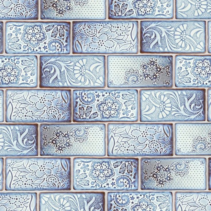 a blue and white tile wallpaper pattern with flowers on it's sides, as well as an ornate design