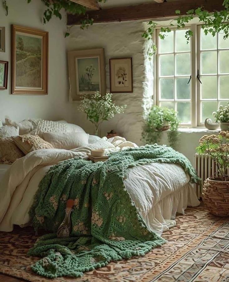 a bed sitting in a bedroom next to a window with plants on the side of it