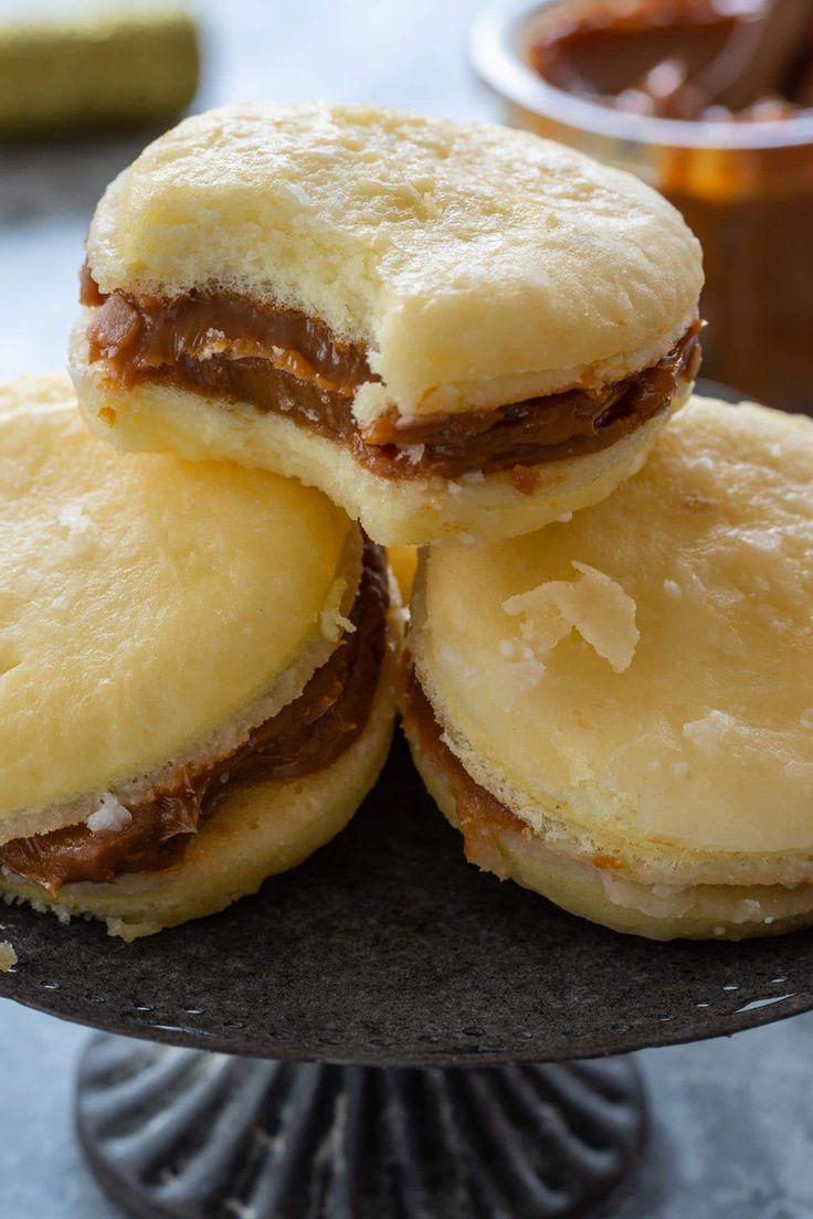 three pastries stacked on top of each other in front of a bowl of dipping sauce