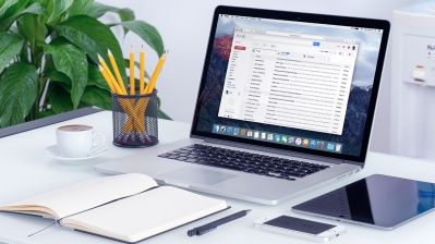 an open laptop computer sitting on top of a white desk