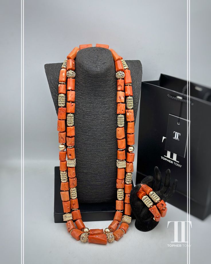 Description Our stunning Coral Bead Necklace and African pendant set are a perfect choice for anyone searching for a unique and eye-catching piece of jewellery. This ethnic necklace is ideal for fashion-forward individuals, who want to add a touch of elegance to their ensemble. Crafted from high-quality coral beads, this African beaded necklace features an intricate design that is a perfect reflection of the rich African cultures and traditions. With this fabulous necklace, you're sure to stand Traditional Coral Beaded Necklaces With Polished Beads, Traditional Coral Necklace With Polished Beads, Traditional Coral Necklace With Gemstone Beads, Traditional Handmade Red Coral Beads, Traditional Coral Beaded Necklaces, Handmade Oval Beads Red Coral Jewelry, Traditional Coral Gemstone Beads, Handmade Red Coral Oval Beads Jewelry, Handmade Red Coral Jewelry With Oval Beads