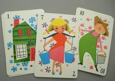 three playing cards with images of women and houses on them, one is for children