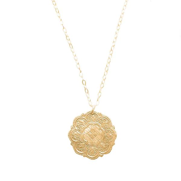 Cast from a pair of antique earrings hand carved by Romani peoples in the 1800s, Rebekah has treasured the originals as a part of her personal collection. Delicate scalloped edging gives the pendant a unique silhouette while intricate engraved details resemble patterns of sacred geometry.  Handcrafted in 14k vermeil or Romani Earrings, Elegant Handmade Coin Necklace, Handmade Elegant Coin Necklace, Elegant Brass Medallion Necklace With Large Pendant, Yellow Gold Bohemian Medallion Necklace, Bohemian Yellow Gold Medallion Necklaces, Spiritual Yellow Gold Medallion Necklace With Large Pendant, Traditional Handmade Medallion Jewelry, Bohemian Yellow Gold Medallion Necklace