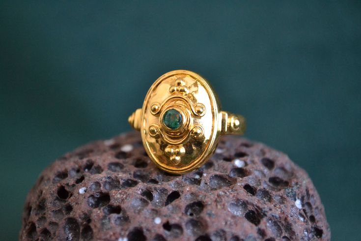 This byzantine inspired ring is entirely made with solid 18K Gold (750 Gold). In the center of the ring, there is a beautiful round shaped Emerald gemstone. It can also be purchased with Ruby or Sapphire Gemstone instead of Emerald. Byzantine Ceremonial Hallmarked Signet Ring, Gold Byzantine Signet Ring For Ceremonies, Gold Byzantine Signet Ring For Ceremonial Occasions, Gold Byzantine Style Ceremonial Signet Ring, Handmade Medieval Gold Rings, Byzantine Style Emerald Ring In Yellow Gold, Gold Ring With Emerald, Byzantine Ring, Etruscan Jewelry