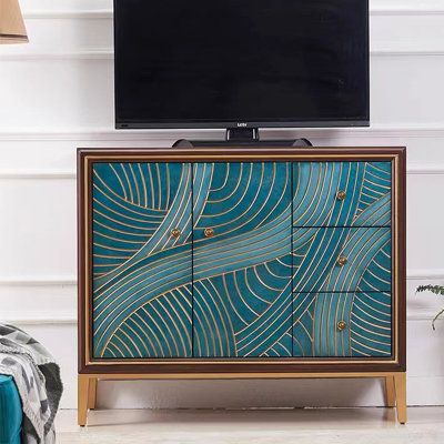 a tv stand with an abstract design on the front and sides, against a white wall