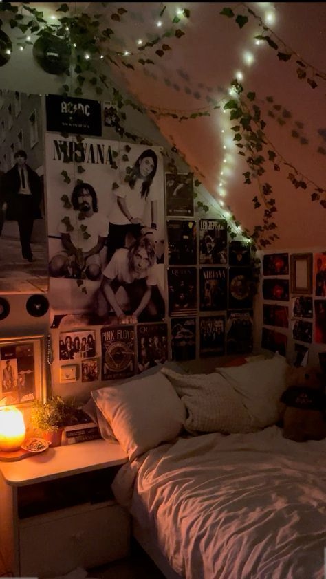 a bedroom with lights and posters on the wall