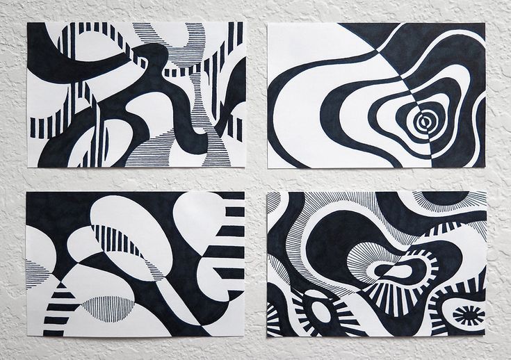 three black and white paintings on a wall