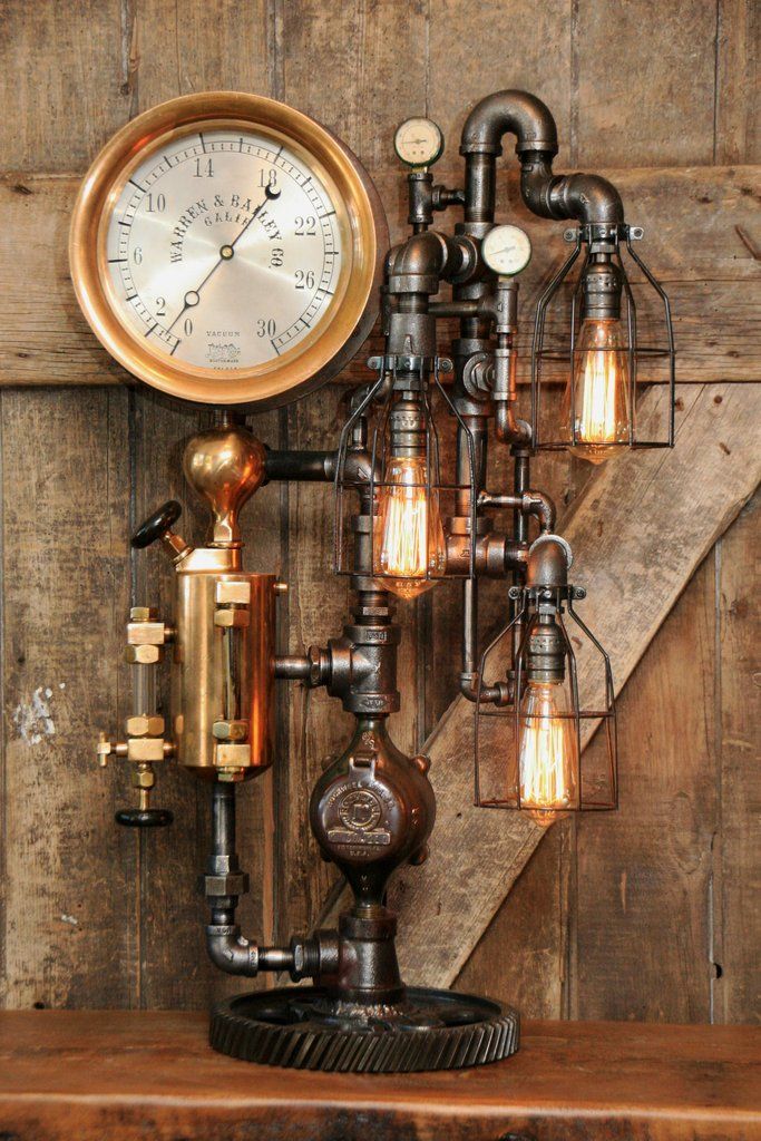 an old fashioned steam engine lamp with a clock on the wall next to it,