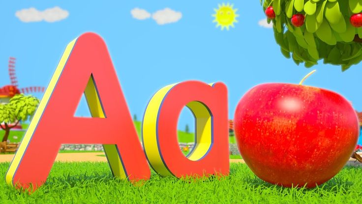 an apple sitting in the grass next to a sign that says aoa and is under a tree