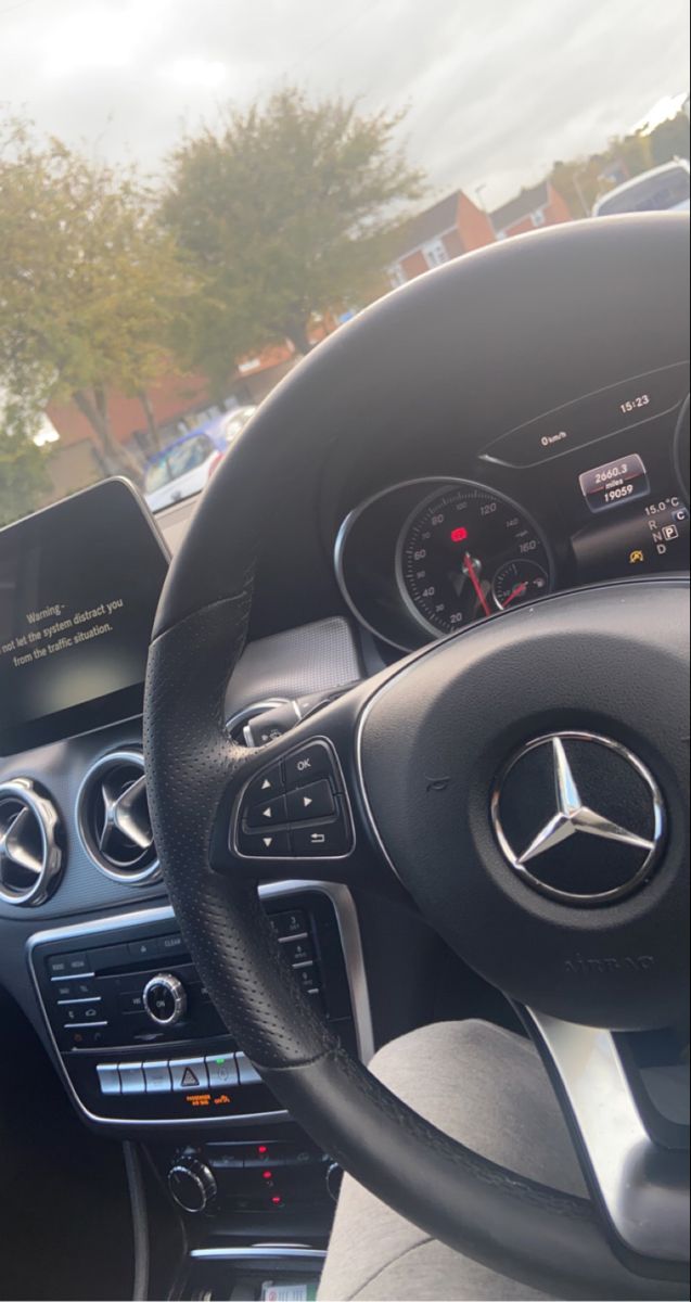 the steering wheel and dashboard of a mercedes benz c - class car with electronic display