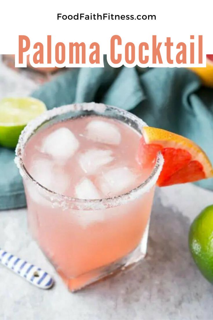 a close up of a drink in a glass with limes and grapefruit