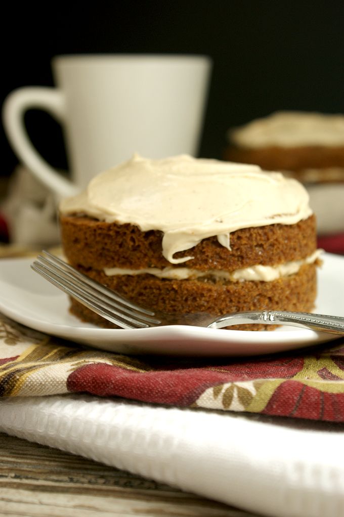 a piece of cake sitting on top of a white plate next to a cup and fork