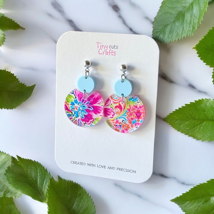 Petite earrings with summer flowers in pink and aqua. These earrings are perfect for adding a touch of feminine style to any outfit. Handcrafted with care, they embody the beauty of nature-inspired jewelry, ideal for beach fashion or as a unique gift for her.. Measuring between 1.75 to 1.60 inches in length and 1 inch in width, they add a pop of color and a touch of boho chic to any outfit. These earrings make a unique gift for her, ideal for birthdays, anniversaries, or just because Crafted fro Summer Light Blue Pierced Earrings, Light Blue Drop Earrings For Summer, Round Flower Earrings As A Summer Gift, Multicolor Summer Flower Charm Earrings, Summer Multicolor Flower Charm Earrings, Blue Flower Earrings For Summer, Nickel-free Flower Drop Earrings For Summer, Trendy Summer Flower Charm Earrings, Summer Multicolor Earrings With Flower Charm