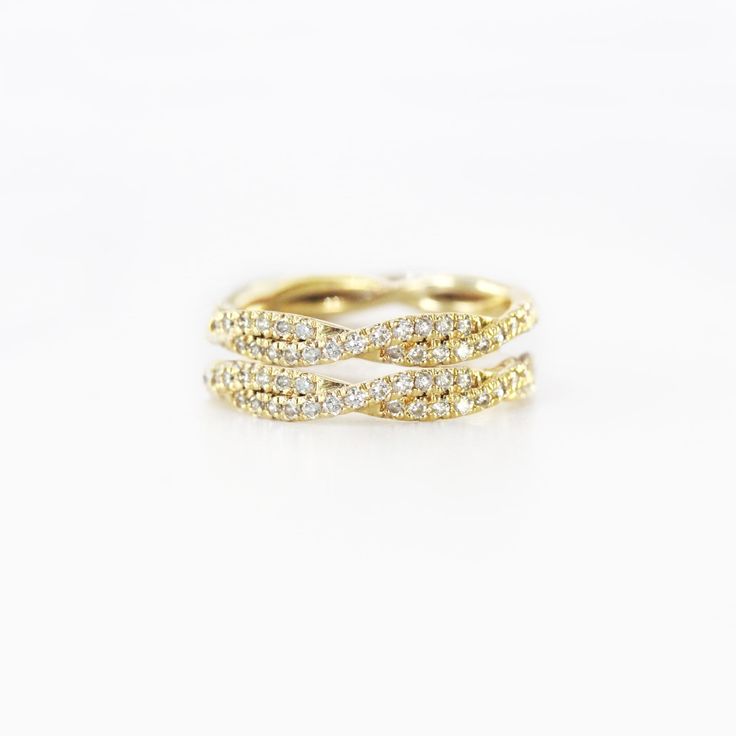 a yellow gold ring with three rows of diamonds