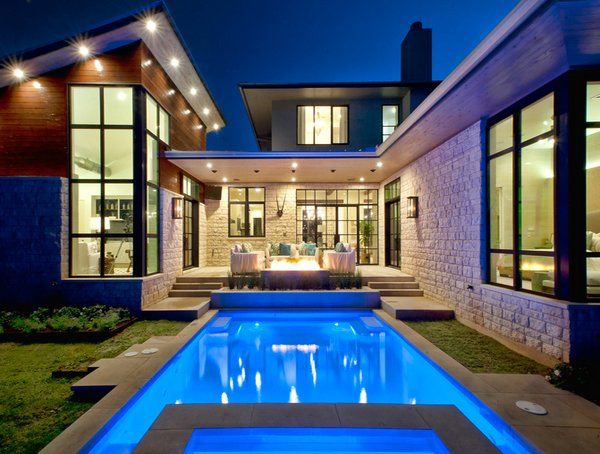 a house that has a pool in the middle of it and some lights on top