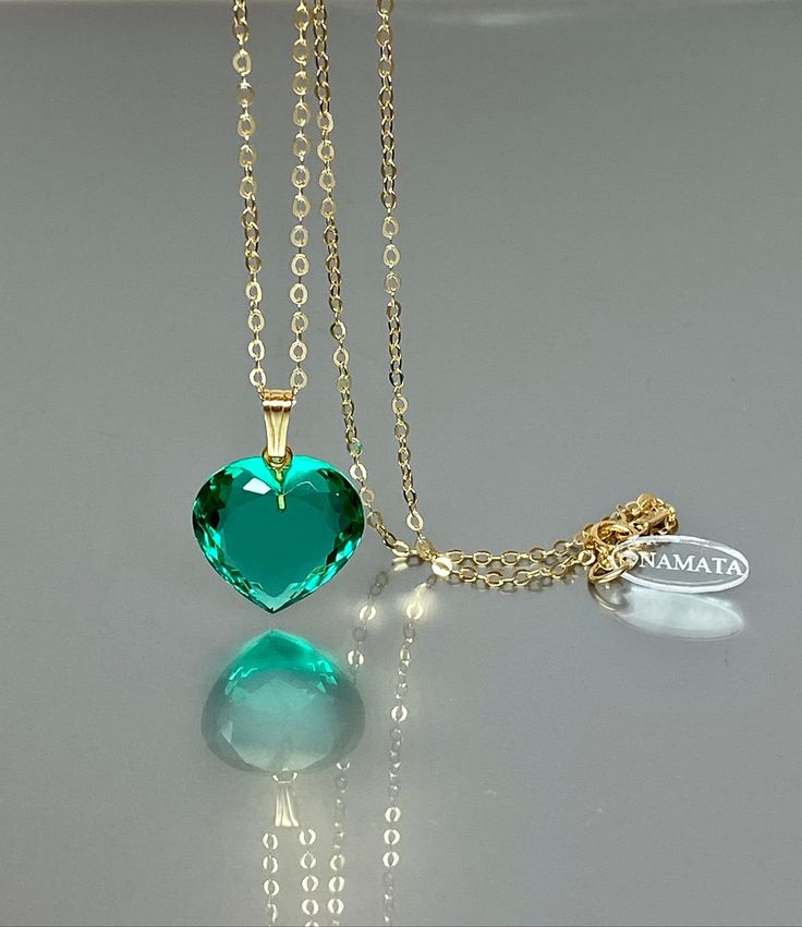 Gorgeous sparkly Colombian emerald heart pendant necklace. The faceted heart shape drops have a beautiful vivid ocean color and reflect lights beautifully. The pendant is strung on a 14K gold filled/ Sterling Silver chain. It is perfect for layering or looks great when worn alone. *Excellent quality AAA+ Flawless Colombian emerald heart pendant(26ct). *Pendant measure (without the bail): 22mmx22 mm /0.9x 0.9 inch *Metal: 14K gold-filled/ Sterling Silver *Necklace length: 45 cm /18 inch Solid gol Emerald Heart Charm Jewelry, Heart-shaped Emerald Necklace For Gift, Heart Cut Emerald Necklace For Gift, Green Heart-shaped Jewelry Gift For Her, Heart-shaped Emerald Necklaces As A Gift, Heart-shaped Emerald Necklaces For Anniversary, Heart Shaped Emerald Necklace As A Gift, Heart-shaped Emerald Necklace As A Gift, Heart-shaped Green Emerald Necklace As Gift