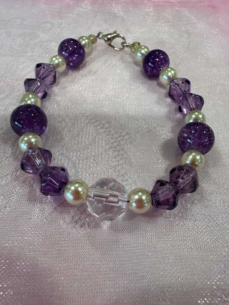 Handmade beaded bracelet, perfect as a small gift! Elegant Stretch Bracelet With Large Beads For Gift, Elegant Stretch Bracelet With Large Beads As Gift, Spacer Beads Jewelry For Gift Making, Beaded Crystal Bracelet Gift, Elegant Purple Beaded Bracelets As Gift, Elegant Purple Beaded Bracelets For Gift, Elegant Purple Beaded Bracelet For Gift, Elegant Purple Beaded Bracelet Gift, Faceted Crystal Bead Bracelet Gift