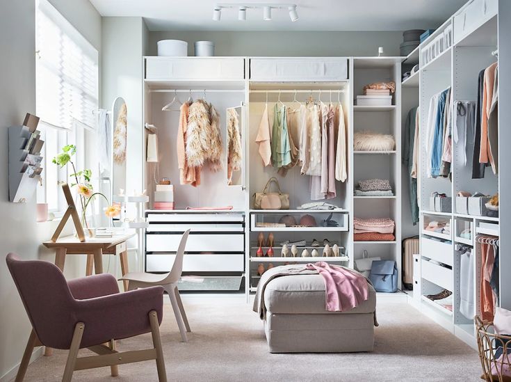 an organized closet with clothes, shoes and other items